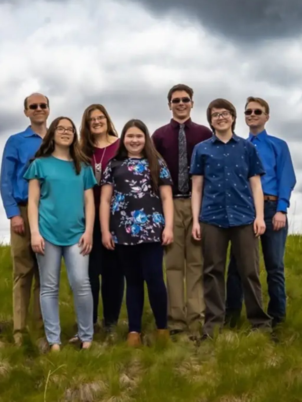 Family photo in a grassy field